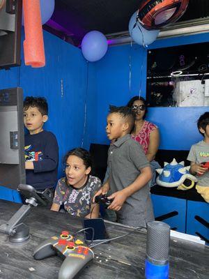 Inside the gaming truck, we can see the kids playing from the outside