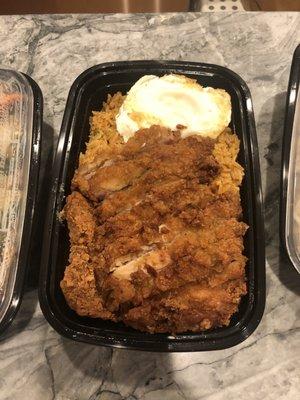 Delicious Indonesian Fried Rice, with fried chicken and egg on top