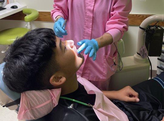 What a relief!!! Dr. Tomasu checking his basketball injured tooth & assessing the severity.