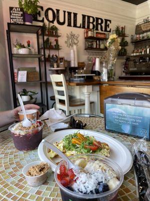 Inside Equilibre eating Acai Bowl + side of peanut butter with Egg Croissant Sandwich - all super delicious!!!!