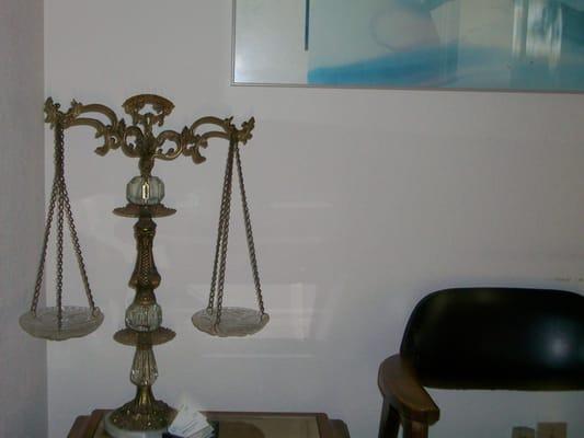 The antique scales of justice are in Al's office.