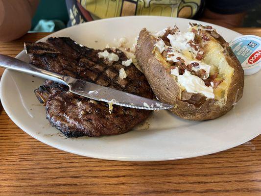 Ribeye steak with loaded potato, also comes with salad bar.