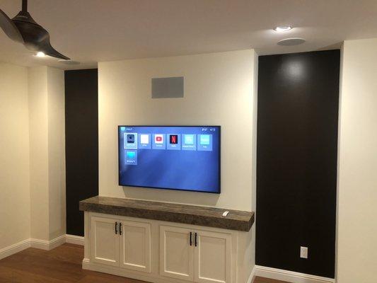 Family room AV setup with in-wall and in in-ceiling surround sound and beautifully Samsung Frame TV