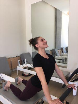 Amelia Bonvento demonstrating down stretch on the reformer! Go go, Gorgeous!