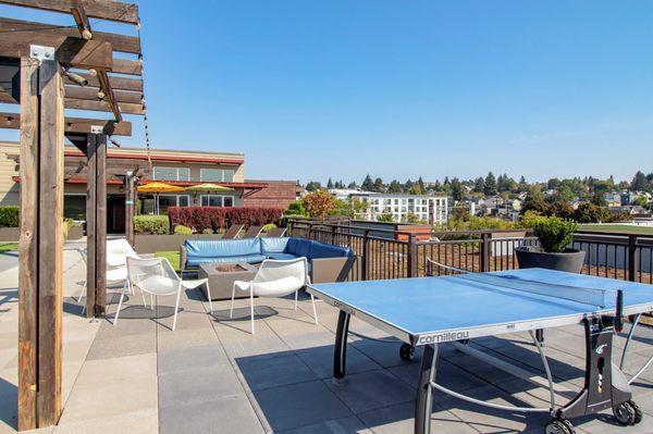 Rooftop terrace with ping pong table and fire pits.