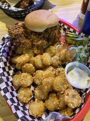 Fried breaded pork tenderloin and tots. Lettuce, Tom, pickles and Mayo are extra