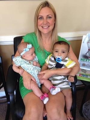 Our Clinic Director, Cynthia, playing with patient's babies while they get treatment with our amazing practitioners!