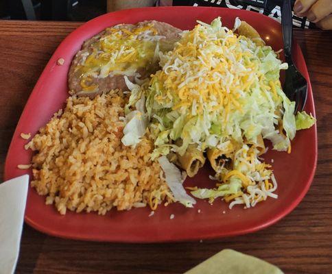 4 rolled tacos, beans and rice