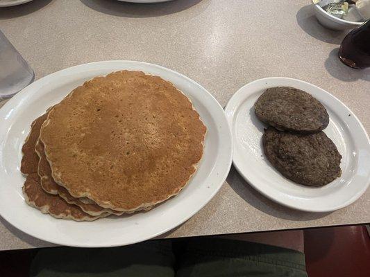 Huge multigrain pancakes and sausage patties.