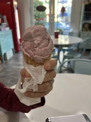 Black cherry ice cream in a waffle cone