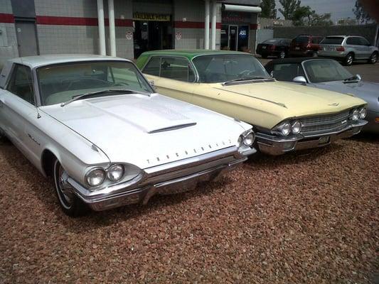 My brother's TBird and my Caddy out in front of Cathedral Automotive.