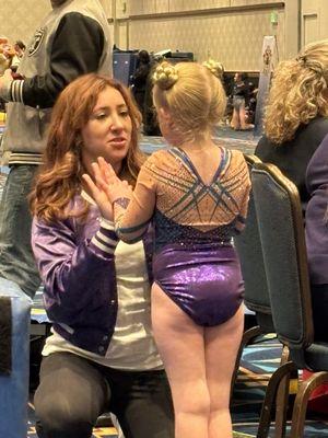 Violet pep talking my daughter after a tough vault warm-up.