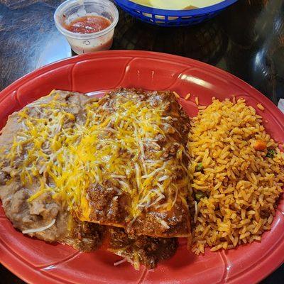 Shredded beef enchiladas with chili sauce.