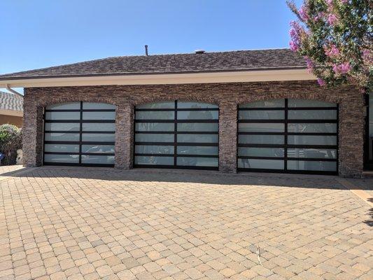 What a fun installation this was! Pictured here are (3) 8'x8' Horizon Amarr Garage Doors. Modern glass garage doors are becoming popular.