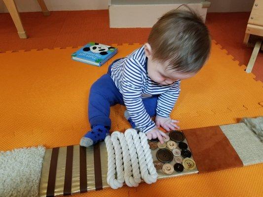 James exploring the texture board custom-made by his teacher