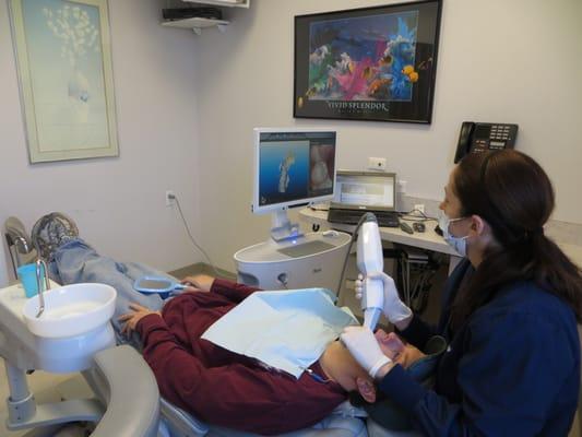 Mary, one of our dental assistants, is using brand new iTero technology to take digital images of the patients teeth