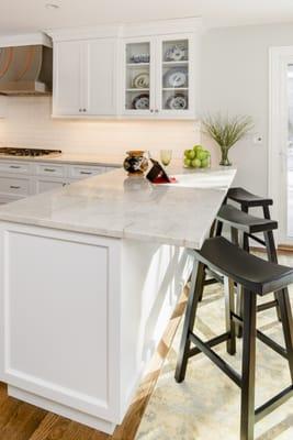 White transitional Kitchen with Perla Venata (Taj Mahal) Quartzite countertops and white beveled subway tile backsplash