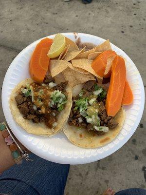 Two carne asada tacos  with beans and chips $2