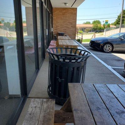 There are a few picnic tables out front you can eat at.