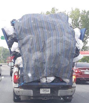 Gray's illegally and dangerously overloaded "garbage trucks" that lose trash all over your neighborhood