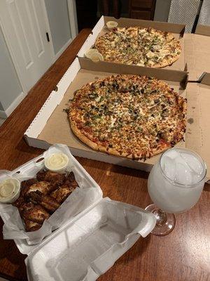 Naked wings with blue cheese and Parmesan garlic sauce on side, Philly Cheesesteak Pizza and Supreme Pizza