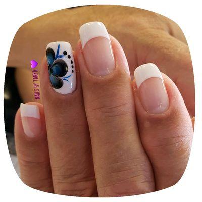 French gel manicure with a beautiful floral accent!