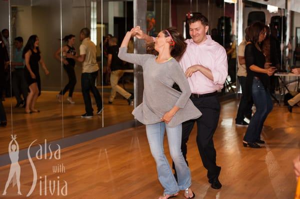 Salsa With Silvia has salsa social dance parties every month where students mingle and practice their moves.