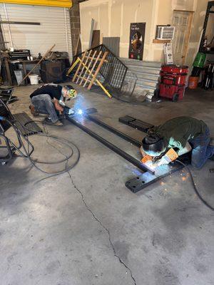 man welding iron in sop