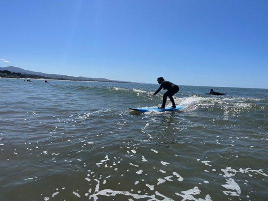 CATCHING SOME BABY WAVES ON MY FIRST LESSON; Picture includes another awesome beginner from the group class like me on the water