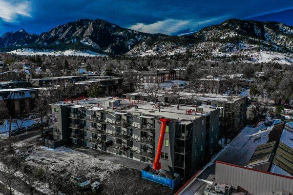 Multifamily apt. complex re-roof in Boulder, CO. Removed tar & gravel roof and installed Rhino-Bond, TPO system with R-38 fully tapered.