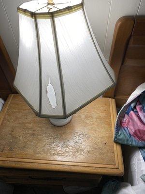 Lamp shade with a cigarette burn