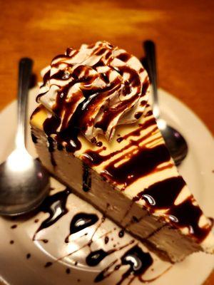 Cheesecake with chocolate drizzle and whip cream