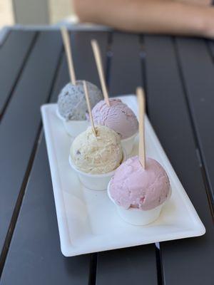 Flight of 4 mini scoops: Black sesame, honey lavender, cardamom pistachio kulfi, and rose