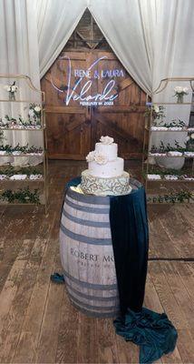 3-tier wedding cake and shelves with desserts