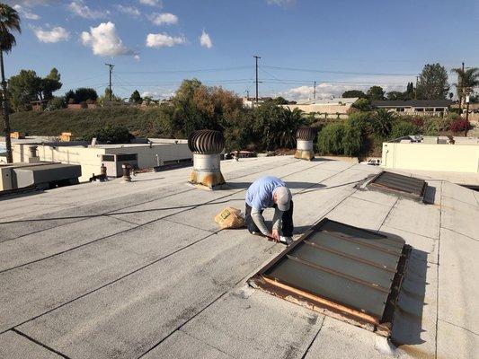 Our technician Trevor tearing out a 50 year old skylight in preparation for a replacement.