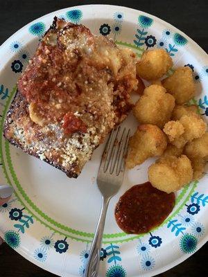 One slice (of eight) and half of the cauliflower wings order. Very spicy Buffalo sauce on the side.