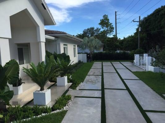 Pinecrest new home with green landscape. Nature's Dream also did the concrete driveway,artificial sod installation, LED lights and landscape