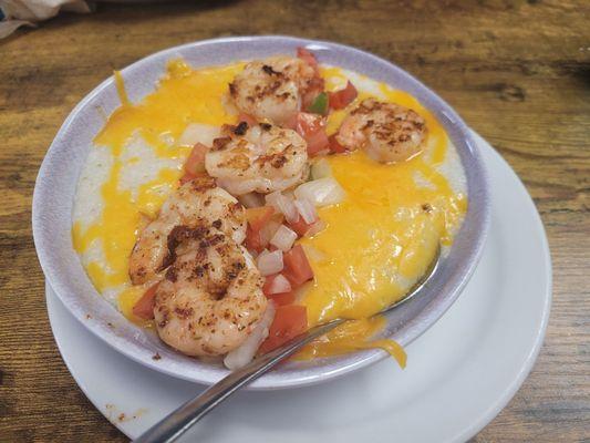 Grits with cheese, topped wih shrimp.