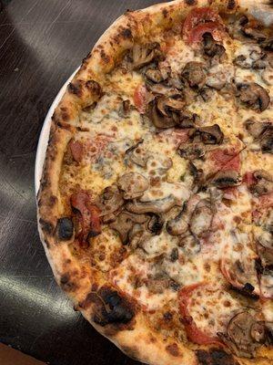 Pepperoni and mushroom pizza with pesto