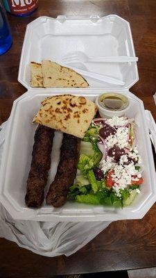 Beef kabobs with salad and pita