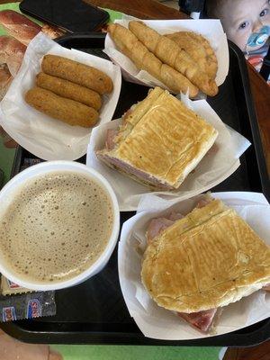 Croquetas, Cuban sandwich, cafe con leche, empanada, and deditos de guayaba y queso