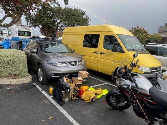 Tow truck trying to snake the truck out of the parking space.
 My tools piled in the parking lot awaiting a ride...