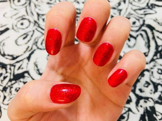 Glittery red gel manicure