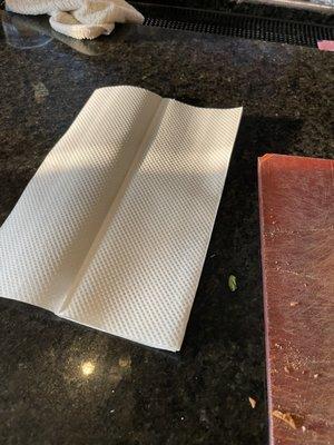 bathroom, paper towels given out as napkins without silverware.