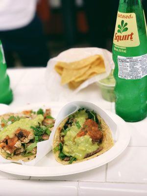 carne asada taco with a pollo quesadilla, a squirt, and chips & guac in the back