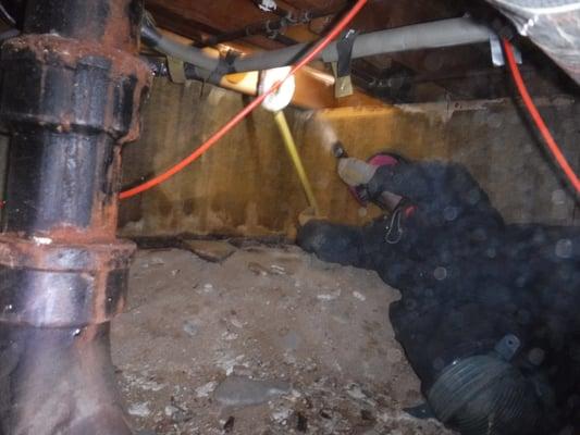 Checking for moisture damage below hall bathroom in crawlspace.