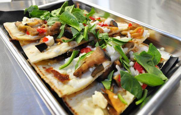 veggie flatbread - arugula oil, baby spinach, grilled eggplant, roasted peppers, feta.