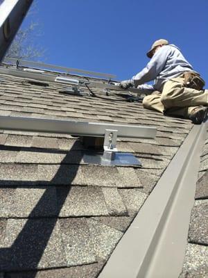 A recent shot of Dave installing racking for a solar array on a house in South Minneapolis.