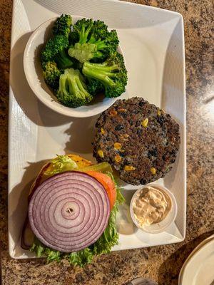 Black bean veggie burger with a side of steamed broccoli.