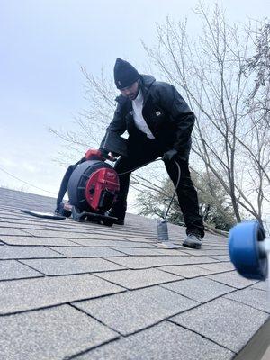 Our Journeyman plumber Tyler doing a sewer camera inspection from the roof while it was 22 degrees out